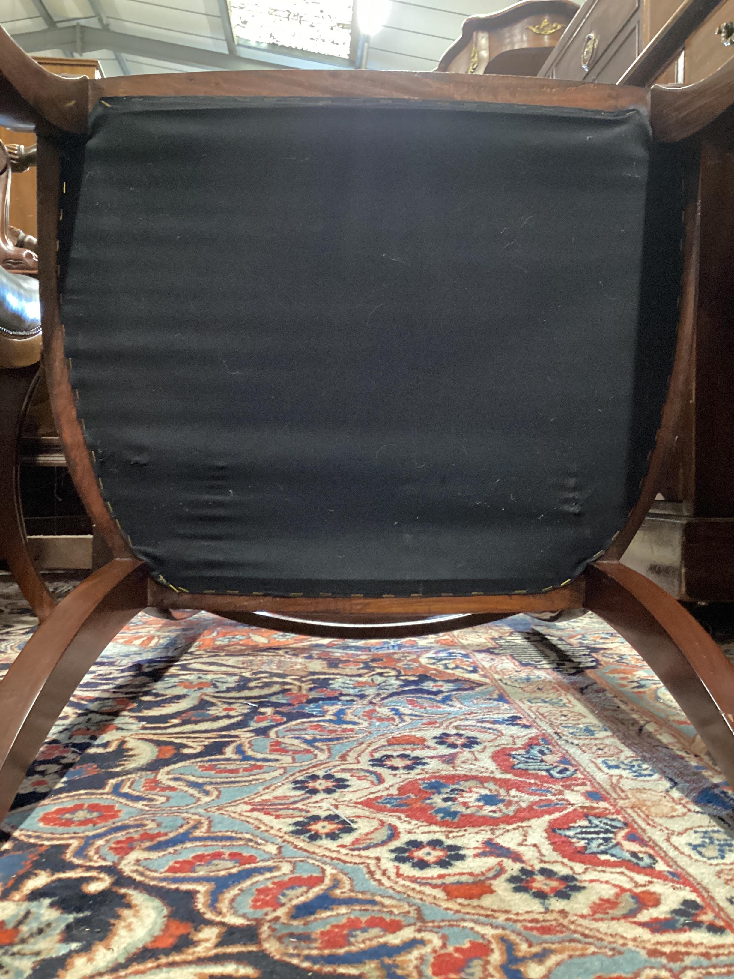 A pair of Regency style mahogany sabre leg elbow chairs, width 56cm, depth 48cm, height 87cm